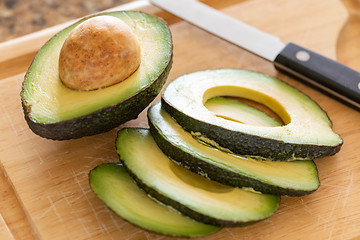 Image showing Fresh Cut Avocado on Wooden Cutting Board