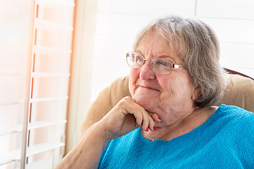 Image showing Content Senior Woman Gazing Out of Her Window