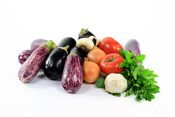 Image showing Pile assorted Eggplants and vegetables on white. 