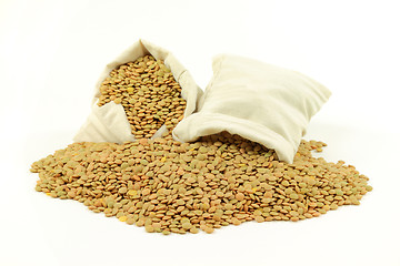Image showing Green lentils in fabric bags and on pile.  
