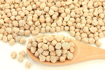 Image showing Chick Peas seeds on pile and in wooden spoon. 