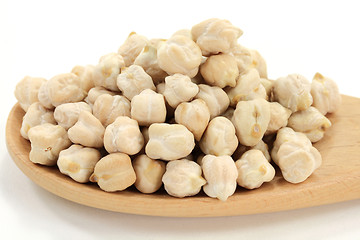 Image showing Chick Peas on pile, in wooden cooking spoon. 