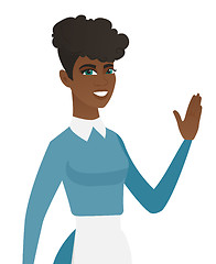 Image showing Young african-american cleaner waving her hand.