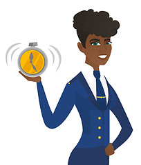 Image showing Arican-american stewardess holding alarm clock.