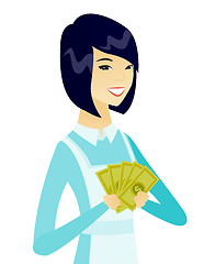 Image showing Young asian cleaner holding money.