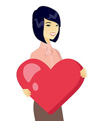Image showing Young asian business woman holding a big heart.