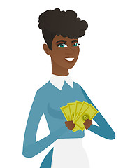 Image showing Young african-american cleaner holding money.