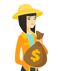 Image showing Upset young asian farmer holding a money bag.