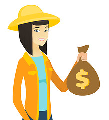 Image showing Young asian farmer holding a money bag.