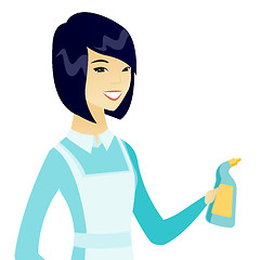 Image showing Young asian cleaner in uniform holding detergent.