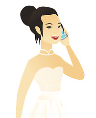 Image showing Young asian fiancee talking on a mobile phone.