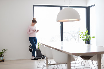 Image showing young woman using tablet computer on the floor