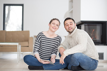 Image showing Young Couple using digital tablet on cold winter day