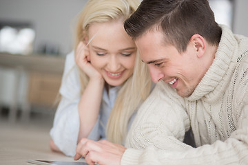 Image showing Young Couple using digital tablet on cold winter day