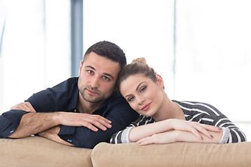 Image showing Portrait of young couple sitting on sofa