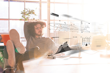 Image showing businessman sitting with legs on desk