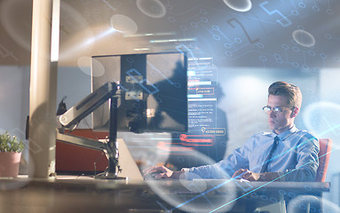 Image showing man working on computer in dark office