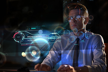 Image showing man working on computer in dark office