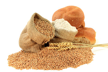 Image showing Raw Wheat Kernels, Flour, Wheatears and Whole Wheat Buns in Burlap Bags on White. 