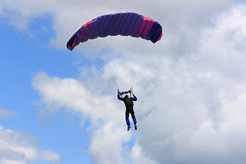 Image showing Skydiver parachuting down to the Earth. 