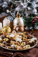 Image showing Assorted Christmas cookies with candles on the table