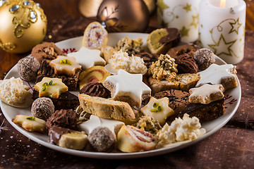 Image showing Assorted Christmas cookies with candles on the table