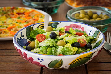 Image showing Small lettuce salad with pizza in background