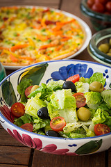 Image showing Small lettuce salad with pizza in background