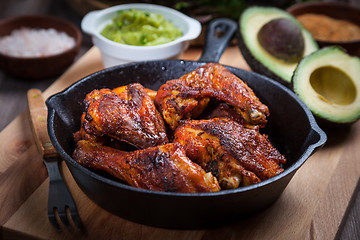 Image showing Grilled hot and spicy chicken wings with guacamole