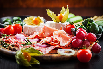 Image showing Gourmet plater of party snacks presented on wooden board