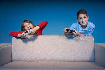 Image showing Computer game competition. Gaming concept. Excited girl playing video game with joystick