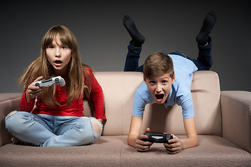 Image showing Computer game competition. Gaming concept. Excited girl playing video game with joystick