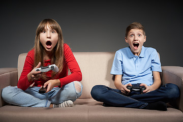 Image showing Computer game competition. Gaming concept. Excited girl playing video game with joystick