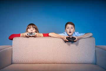 Image showing Computer game competition. Gaming concept. Excited girl playing video game with joystick