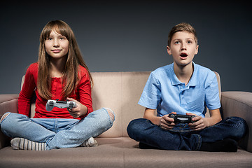 Image showing Computer game competition. Gaming concept. Excited girl playing video game with joystick