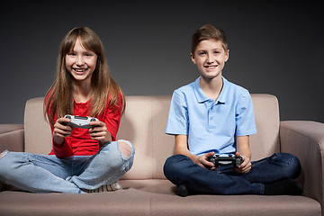 Image showing Computer game competition. Gaming concept. Excited girl playing video game with joystick