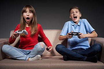 Image showing Computer game competition. Gaming concept. Excited girl playing video game with joystick