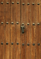 Image showing Ancient Wooden Door with Rivets and Door Knocker