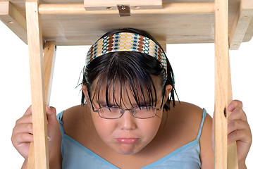 Image showing Girl Hiding Under Table