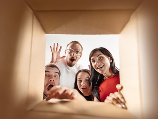 Image showing The people unpacking and opening carton box and looking inside