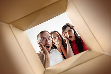 Image showing The people unpacking and opening carton box and looking inside