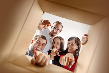 Image showing The people unpacking and opening carton box and looking inside