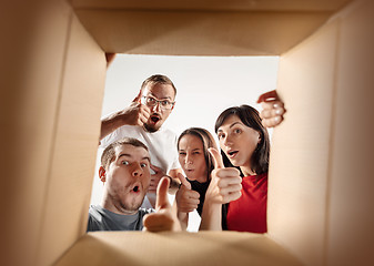 Image showing The people unpacking and opening carton box and looking inside