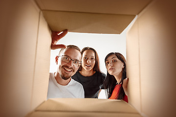 Image showing The people unpacking and opening carton box and looking inside