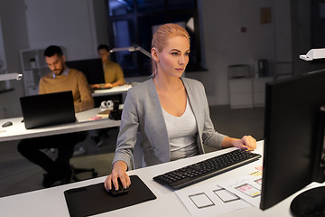 Image showing designer working on computer at night office