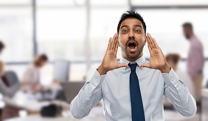 Image showing indian businessman shouting or calling over office