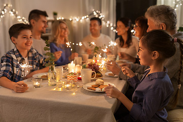 Image showing family with sparklers having dinner party at home