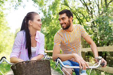 Image showing happy couple with bicycles at summer park