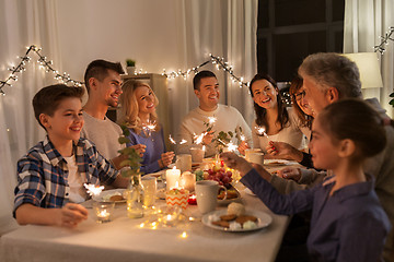 Image showing family with sparklers having dinner party at home