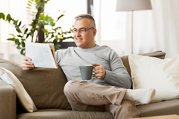 Image showing man reading newspaper and drinking coffee at home